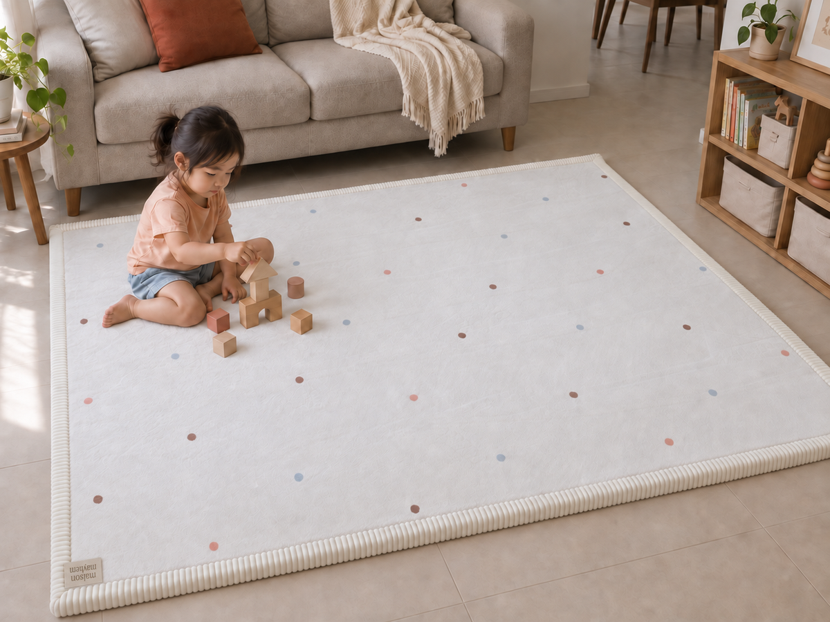 Confetti baby play mat beside a sofa in a Singapore living room